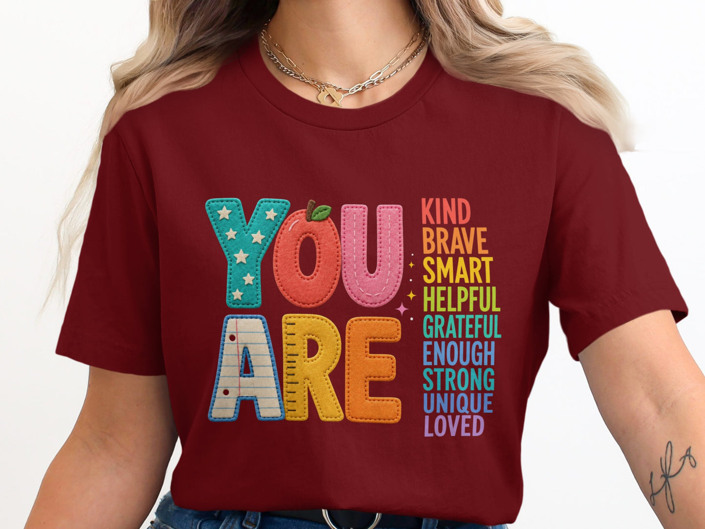 Maroon t-shirt with "YOU ARE" and inspirational words in colorful letters.