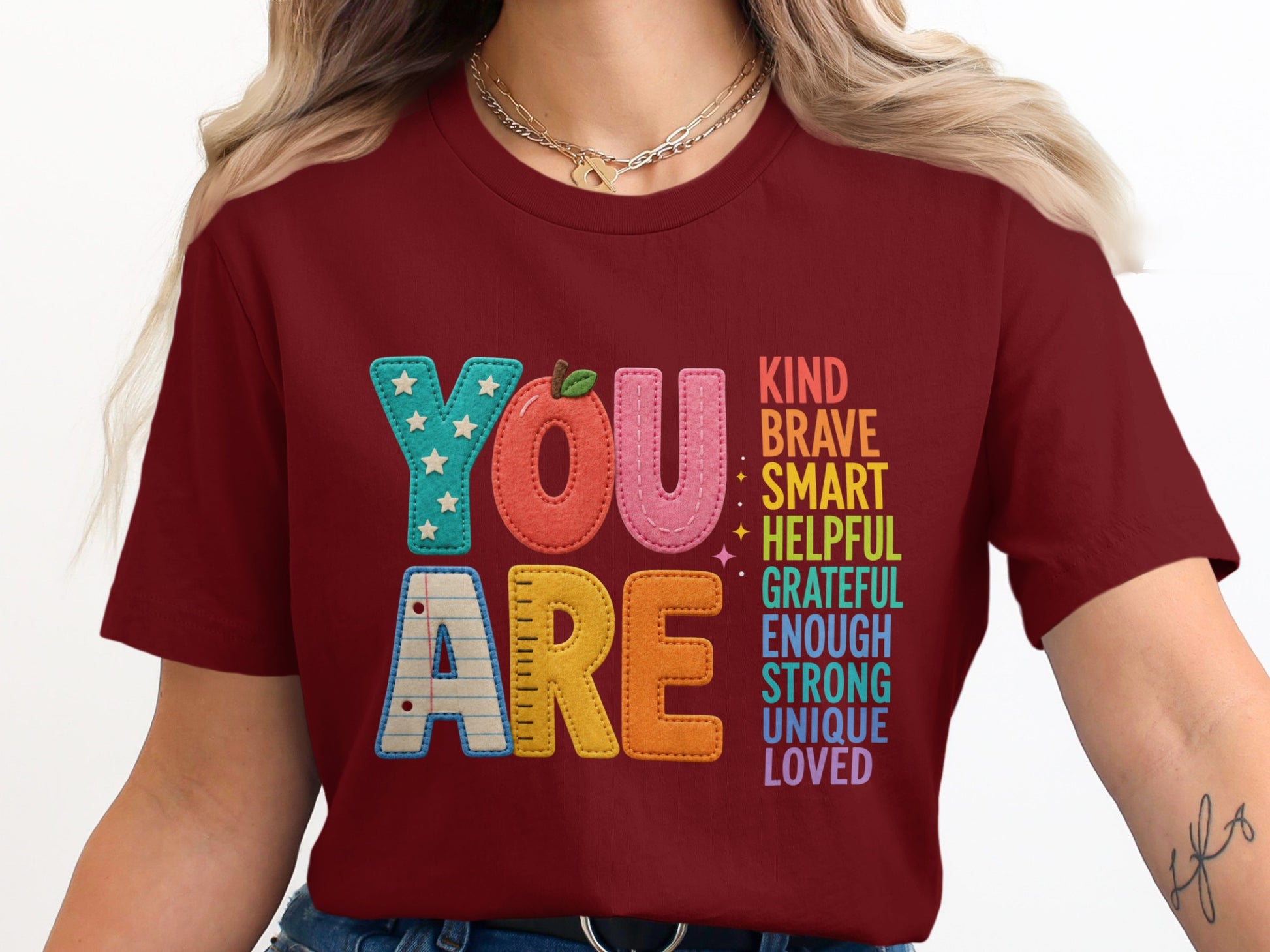 Maroon t-shirt with "YOU ARE" and inspirational words in colorful letters.