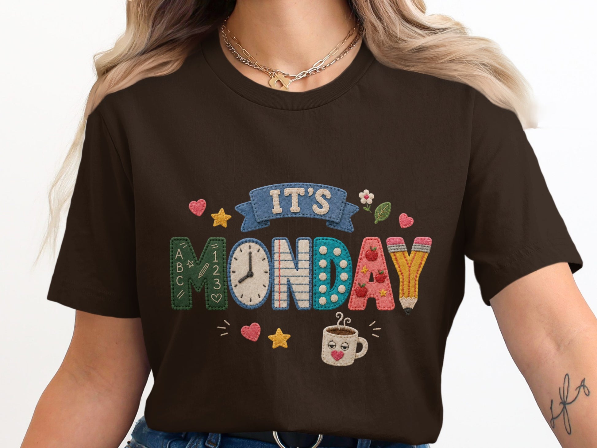 Dark brown t-shirt with "It's Monday" stitched design and school theme elements.