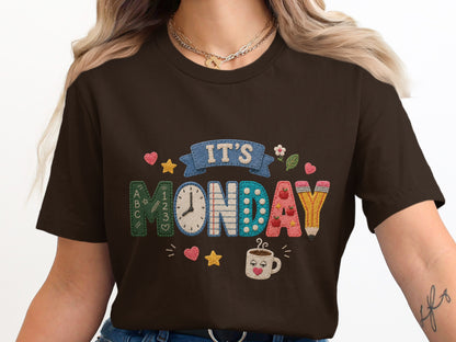 Dark brown t-shirt with "It's Monday" stitched design and school theme elements.