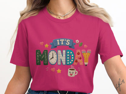 "IT'S MONDAY" graphic with school-themed letters, clock, and coffee cup on a pink shirt.
