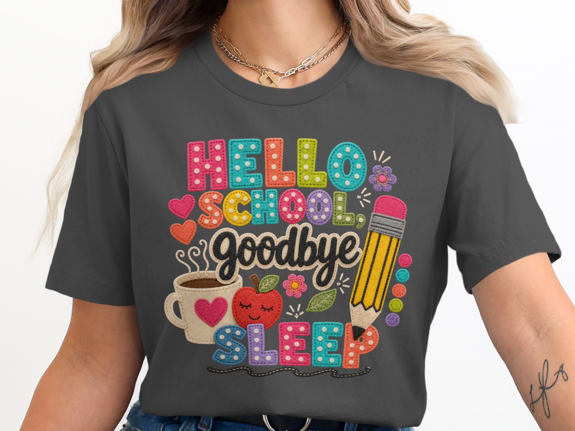 Hello school, goodbye sleep text with apple, coffee, and pencil graphic on a dark grey shirt.