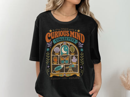 Black t-shirt with "The Curious Mind Collective" and window graphic featuring science icons.