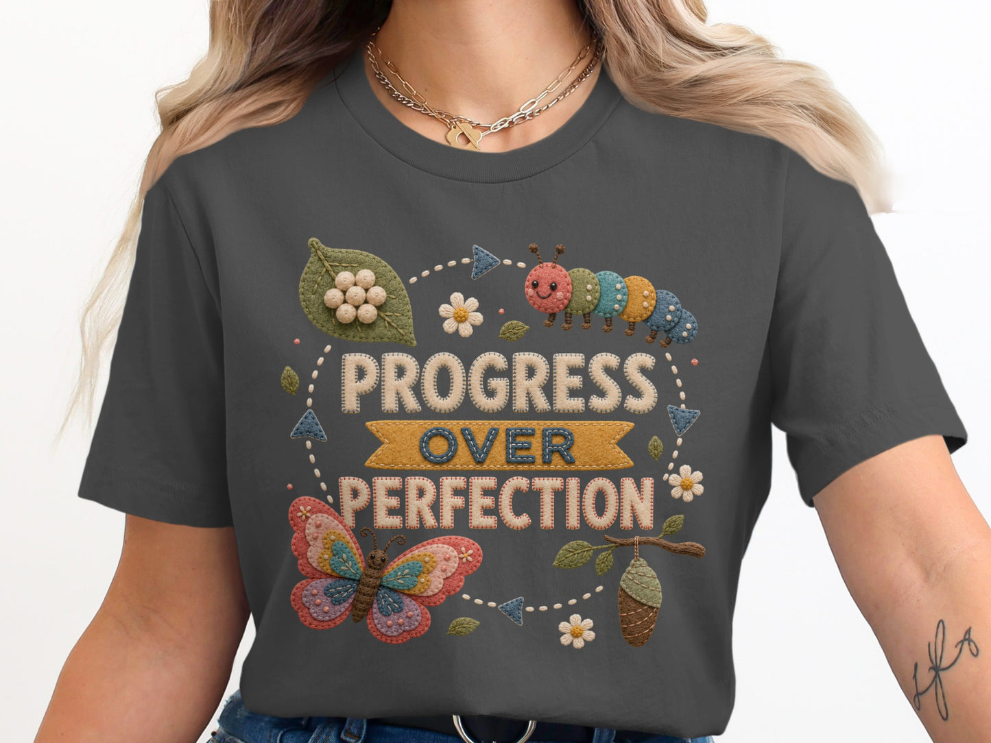 T-shirt with "Progress Over Perfection" text, caterpillar, butterfly, and chrysalis design.