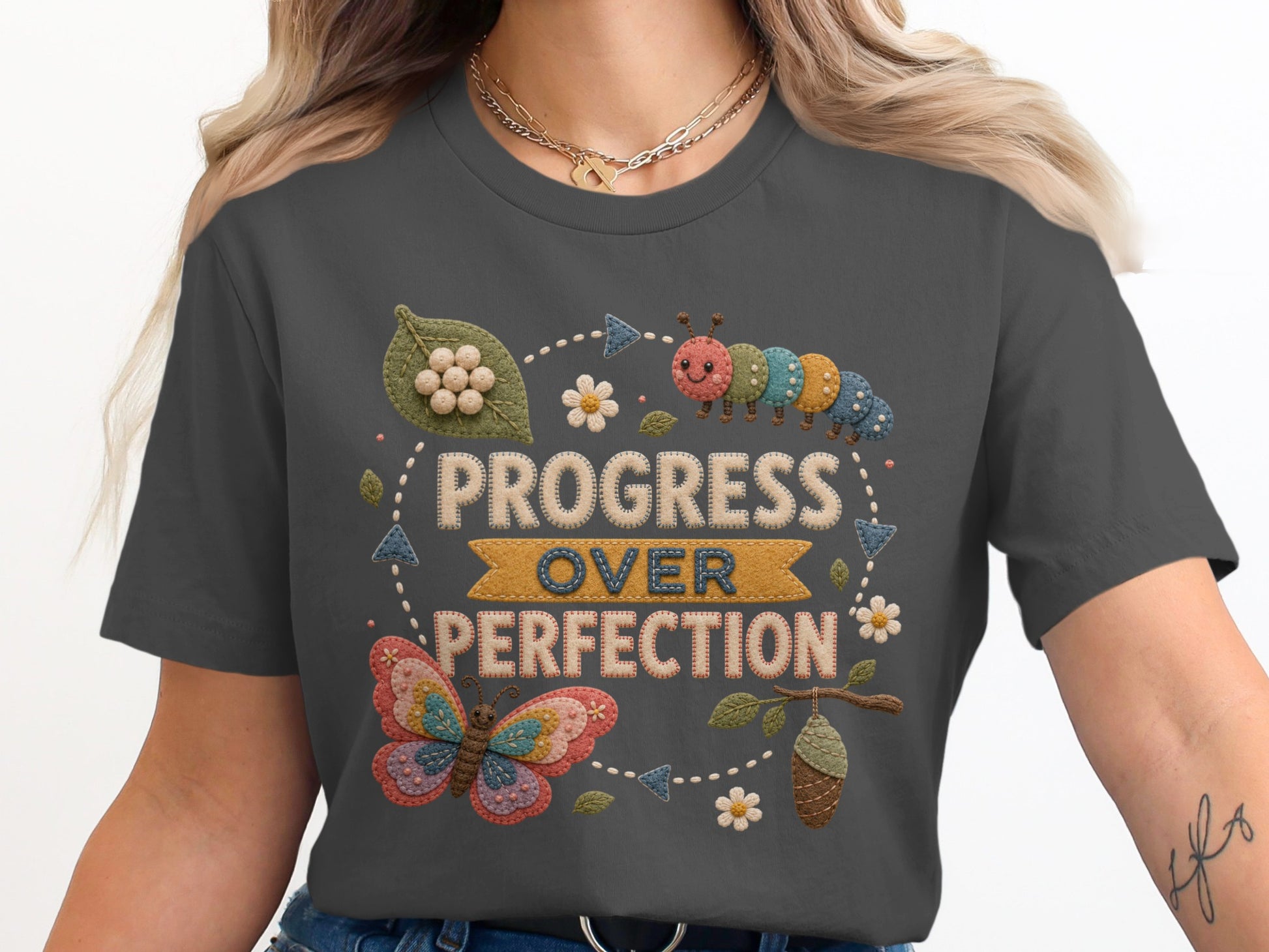 T-shirt with "Progress Over Perfection" text, caterpillar, butterfly, and chrysalis design.