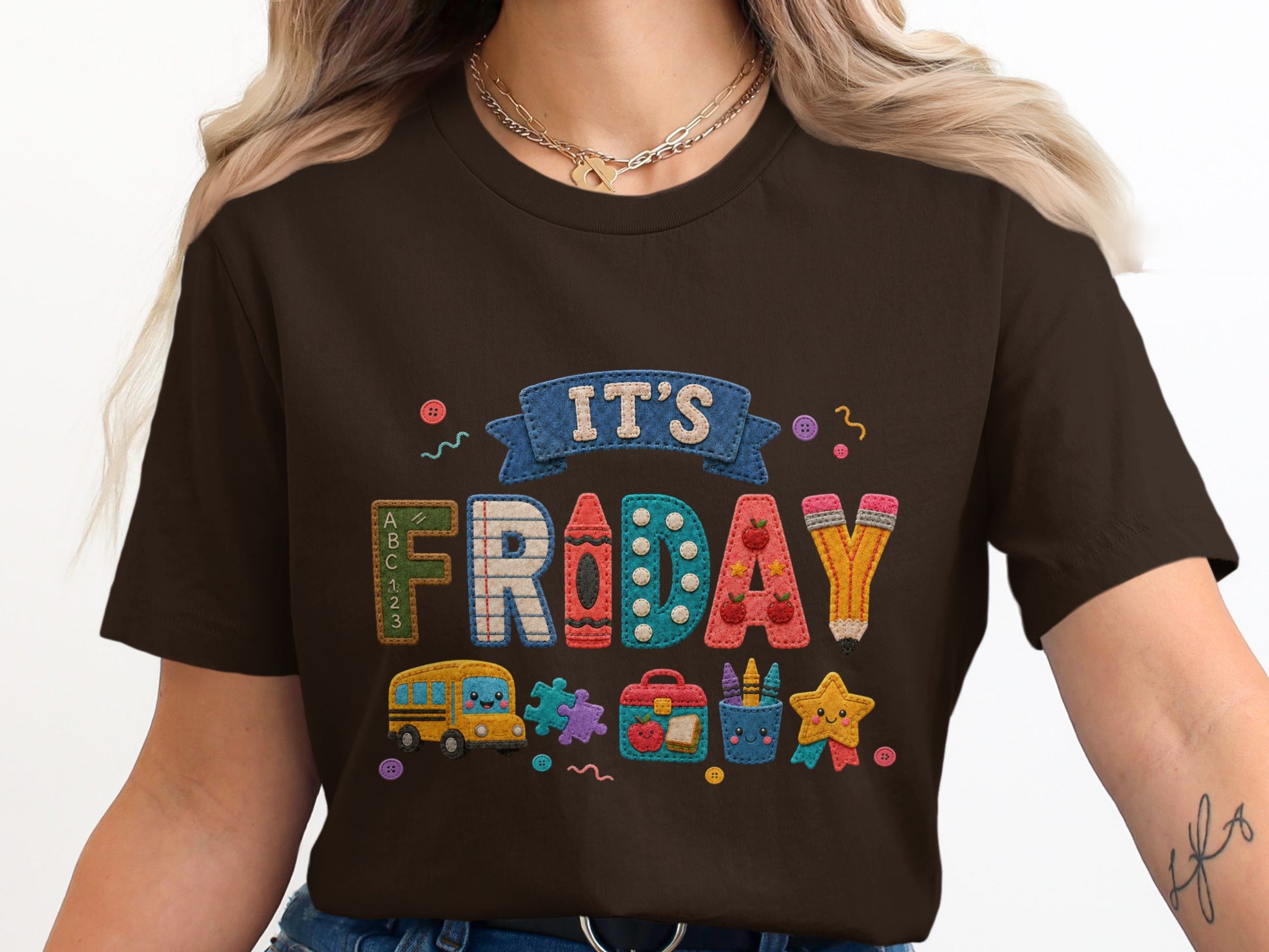 Brown t-shirt with "It's Friday" and school-themed embroidered graphics.