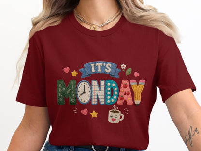 Maroon t-shirt with "IT'S MONDAY" text and school-themed graphics.