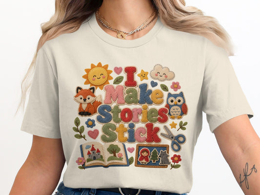 "I Make Stories Stick" text with whimsical felt appliques of a fox, owl, sun, cloud, book, and fairy tale characters.