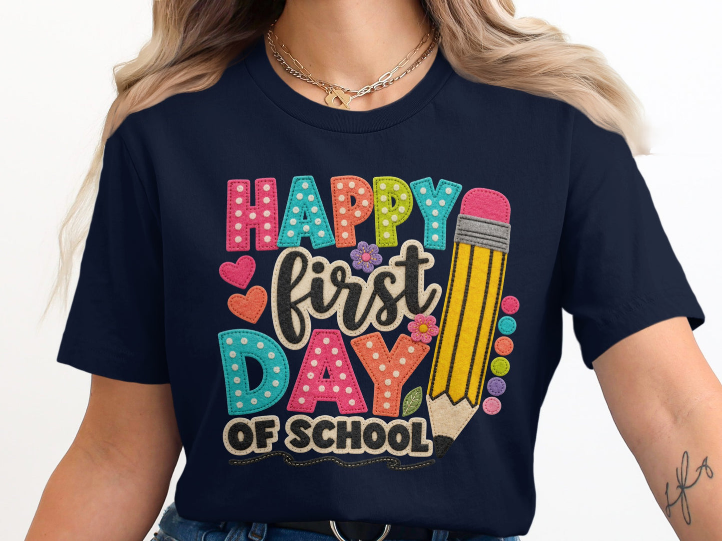 Happy first day of school text on a navy shirt with a pencil graphic.