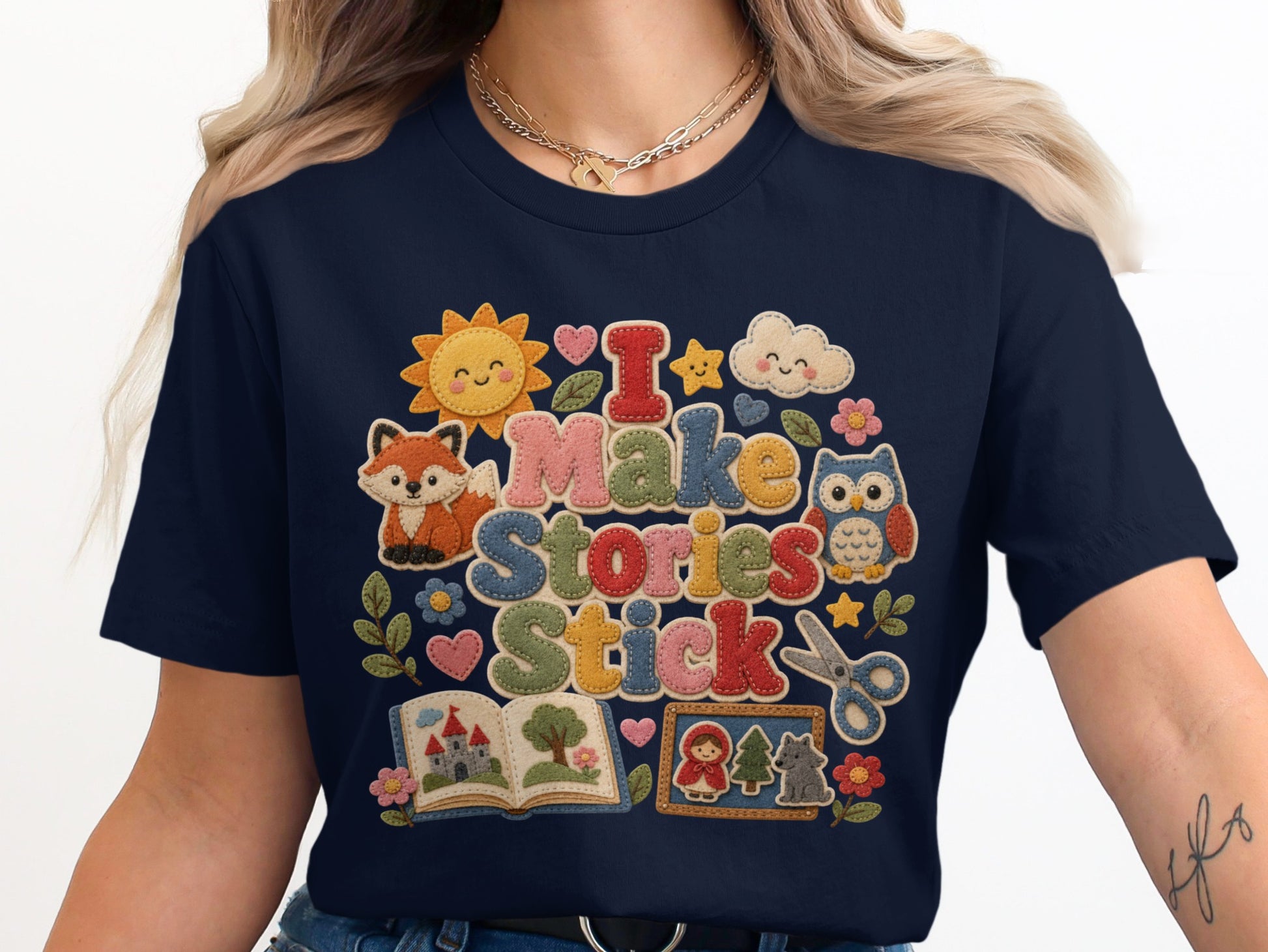 T-shirt with "I Make Stories Stick" and cute illustrated characters.