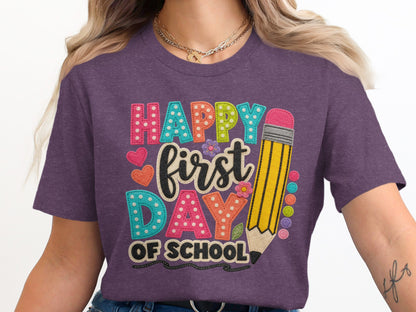 Purple t-shirt with "Happy first Day of School" text and pencil graphic.