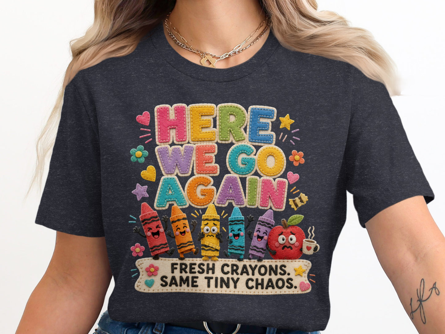"Here We Go Again" graphic tee with colorful crayons and an apple, saying "Fresh Crayons. Same Tiny Chaos."