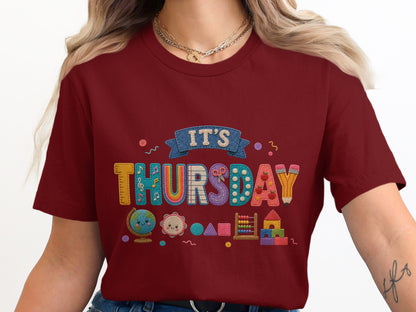 Maroon t-shirt with "IT'S THURSDAY" in colorful letter appliques and school icons.