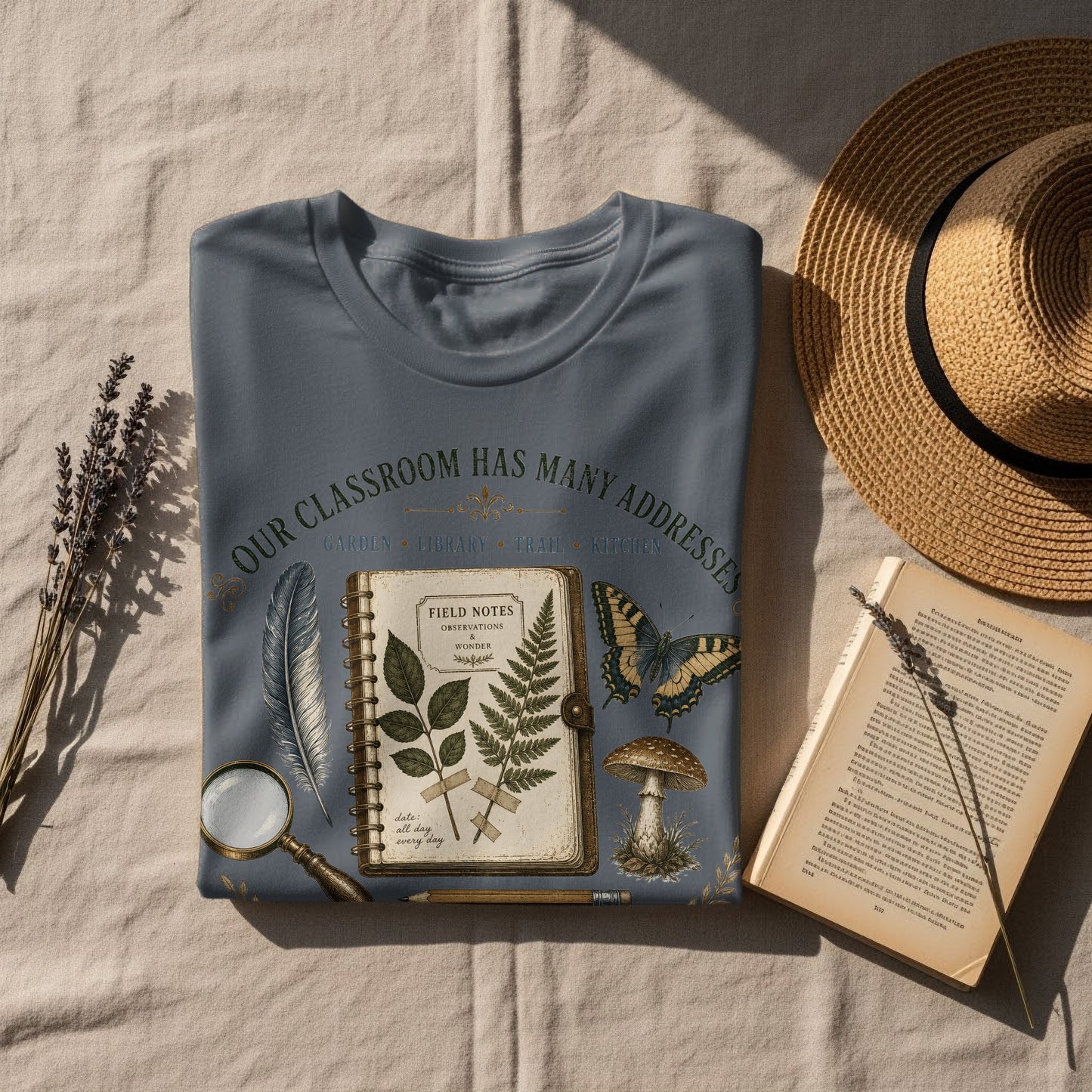 T-shirt with "Our Classroom Has Many Addresses" text and vintage nature illustrations.