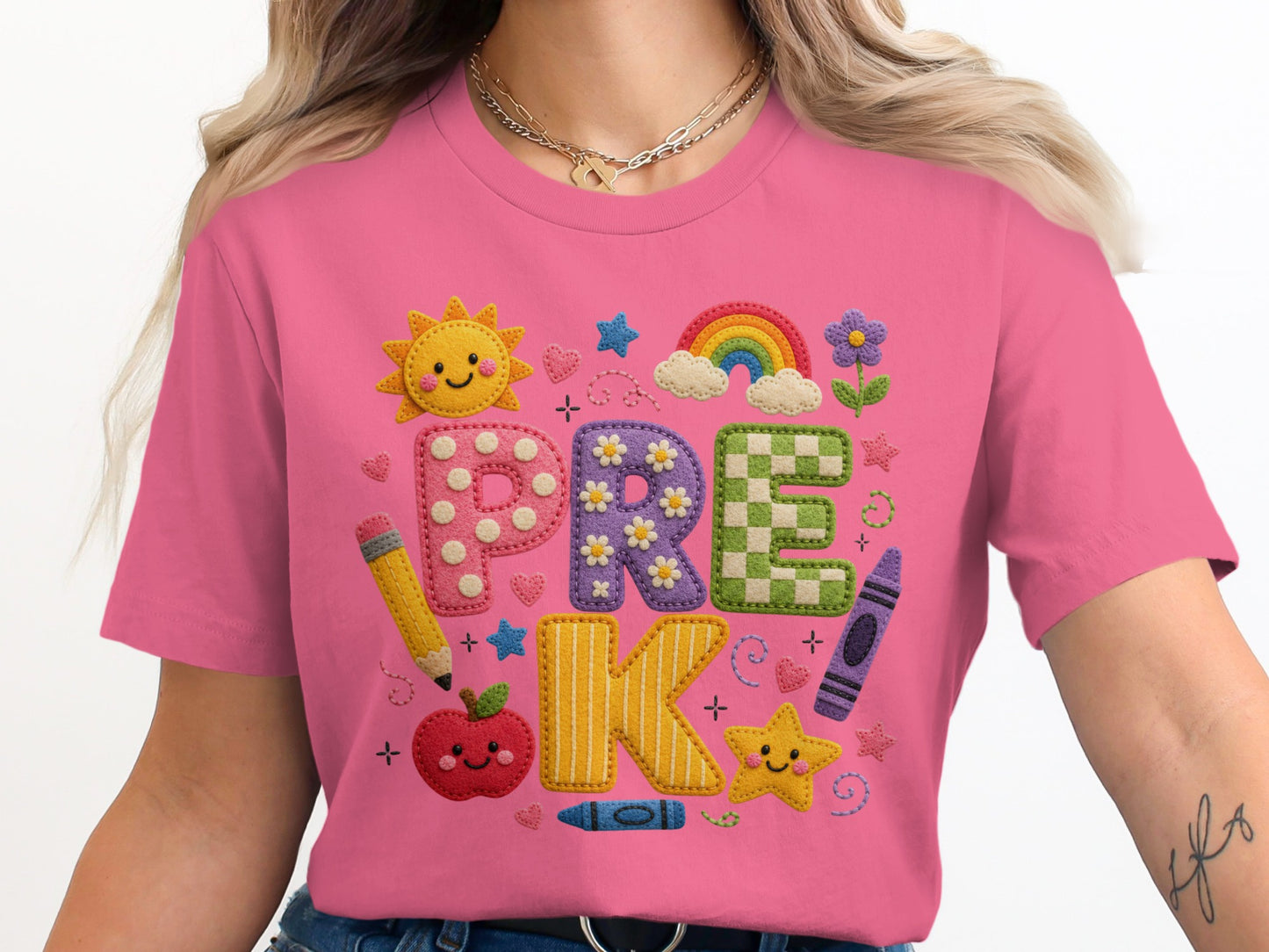 Pink t-shirt with the word "PRE K" spelled out in colorful, textured letters and school-themed graphics.