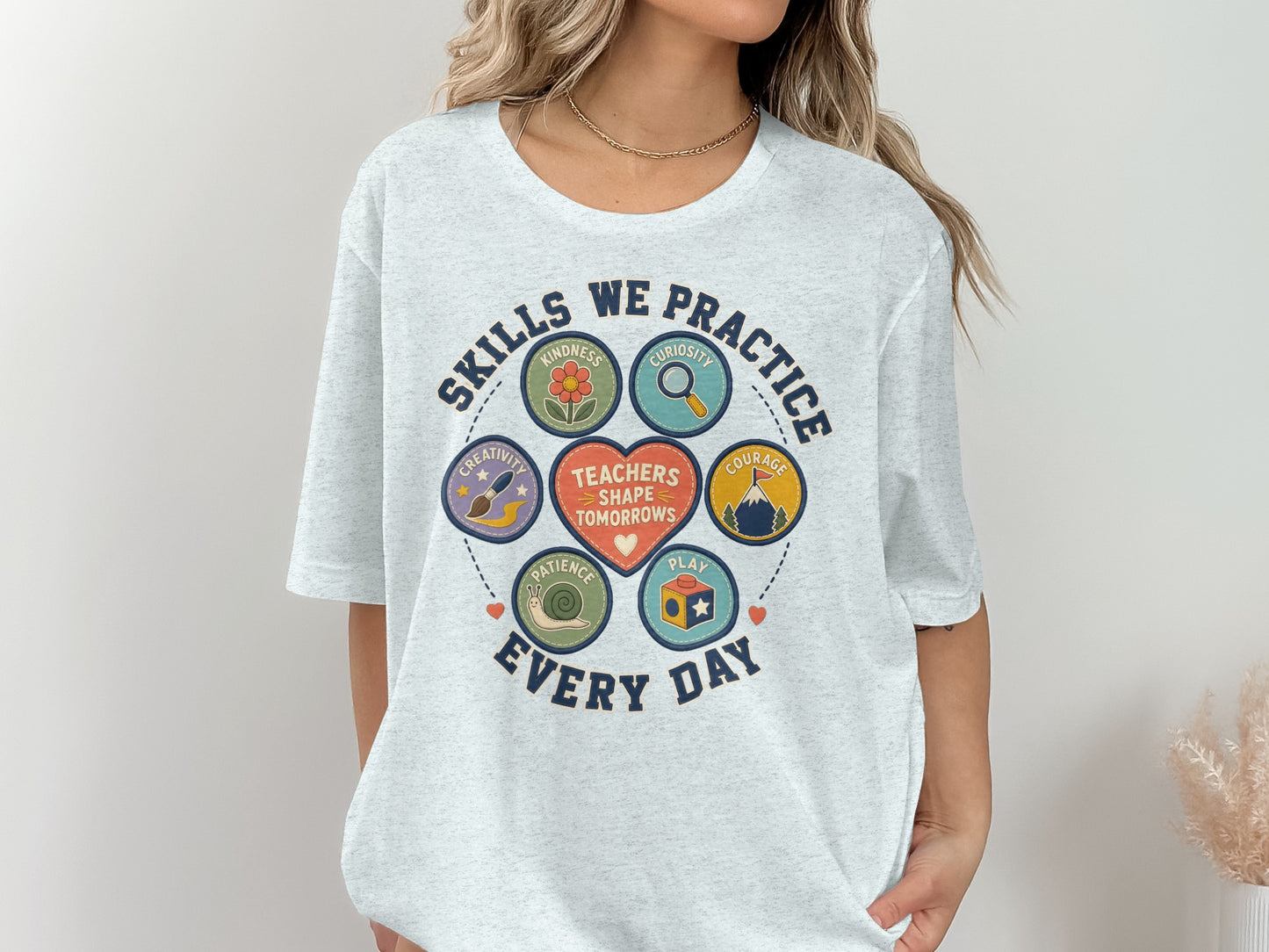 Gray t-shirt with "Skills We Practice Every Day" and teacher's skills icons.