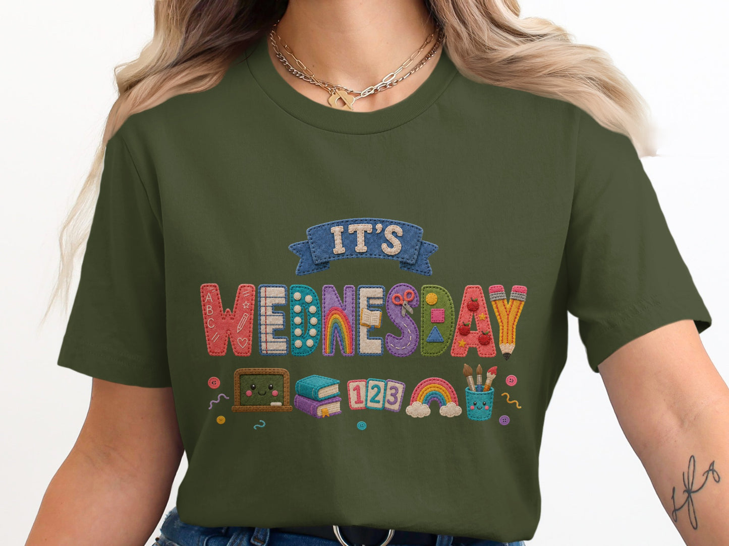 Green t-shirt for kids with "It's Wednesday" and school-themed icons.
