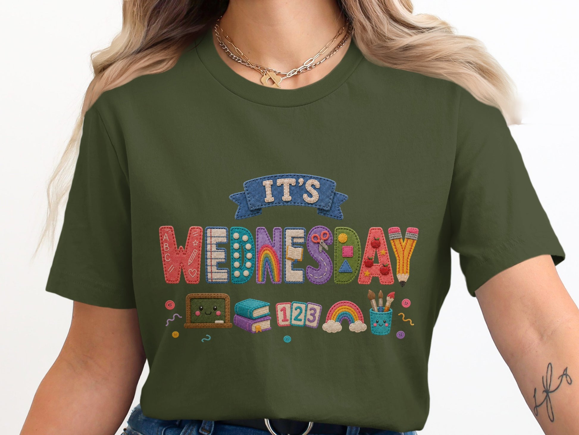 Green t-shirt for kids with "It's Wednesday" and school-themed icons.