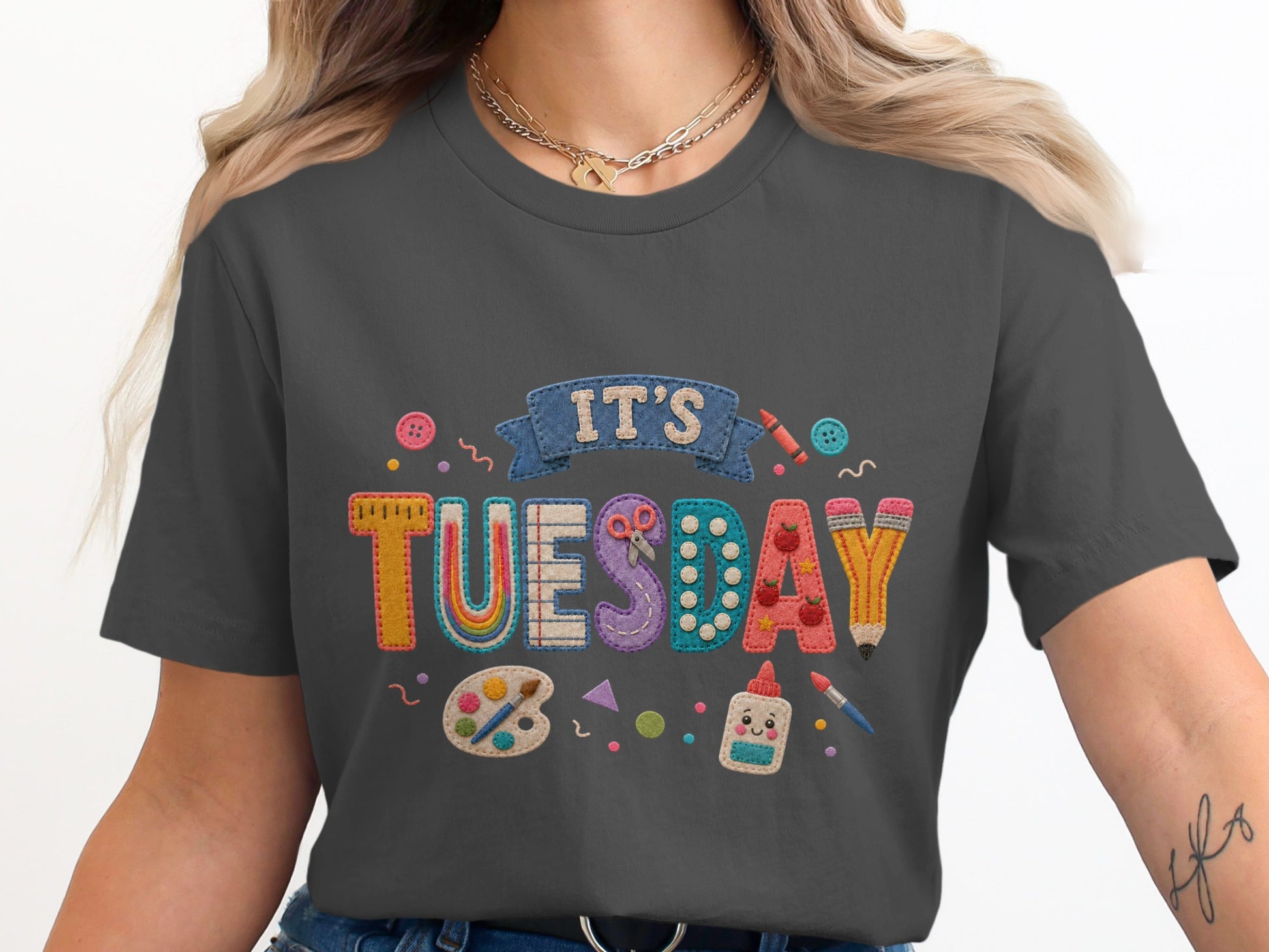 Gray t-shirt with "IT'S TUESDAY" embroidered with school supplies.