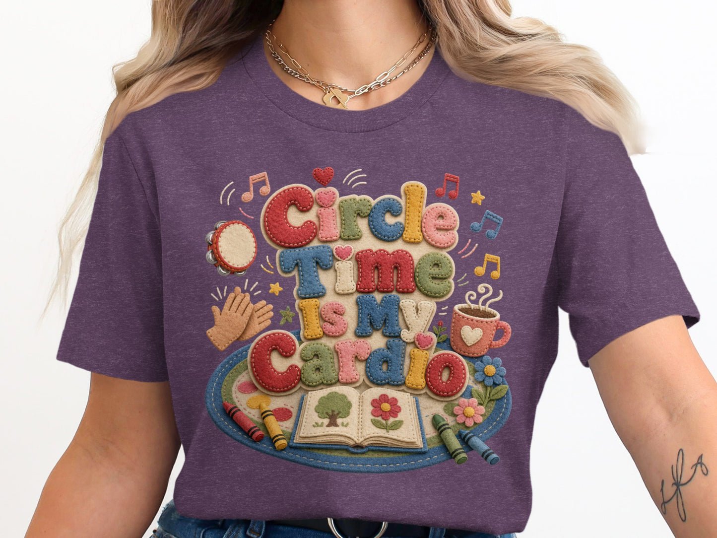 Purple t-shirt with "Circle Time Is My Cardio" graphic and children's art supplies.