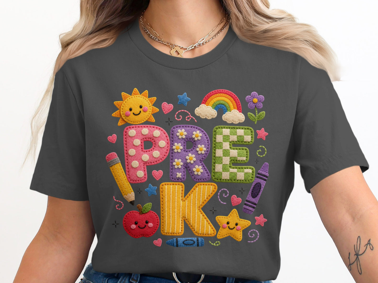 Dark grey t-shirt features applique letters spelling "PRE K" with school themed embellishments.