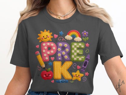 Dark grey t-shirt features applique letters spelling "PRE K" with school themed embellishments.