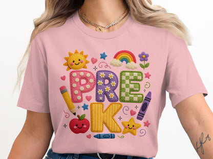 Pink t-shirt with "PRE-K" in colorful appliquéd letters surrounded by school supplies.