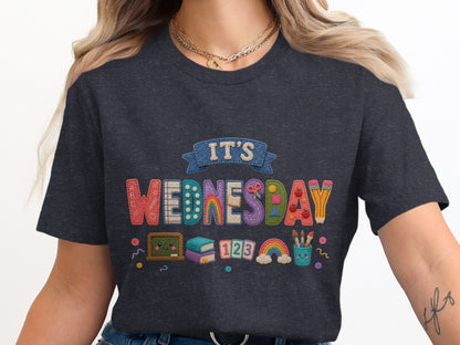Dark t-shirt with "It's Wednesday" in colorful embroidered letters with school supplies.