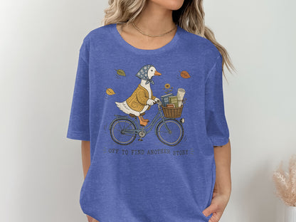 Duck wearing a sweater and bandana rides a bicycle with books and flowers.