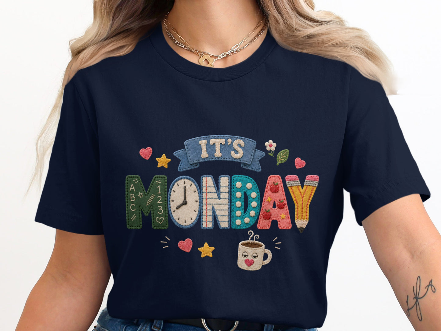 Navy t-shirt with "IT'S MONDAY" text in colorful, textured letters.