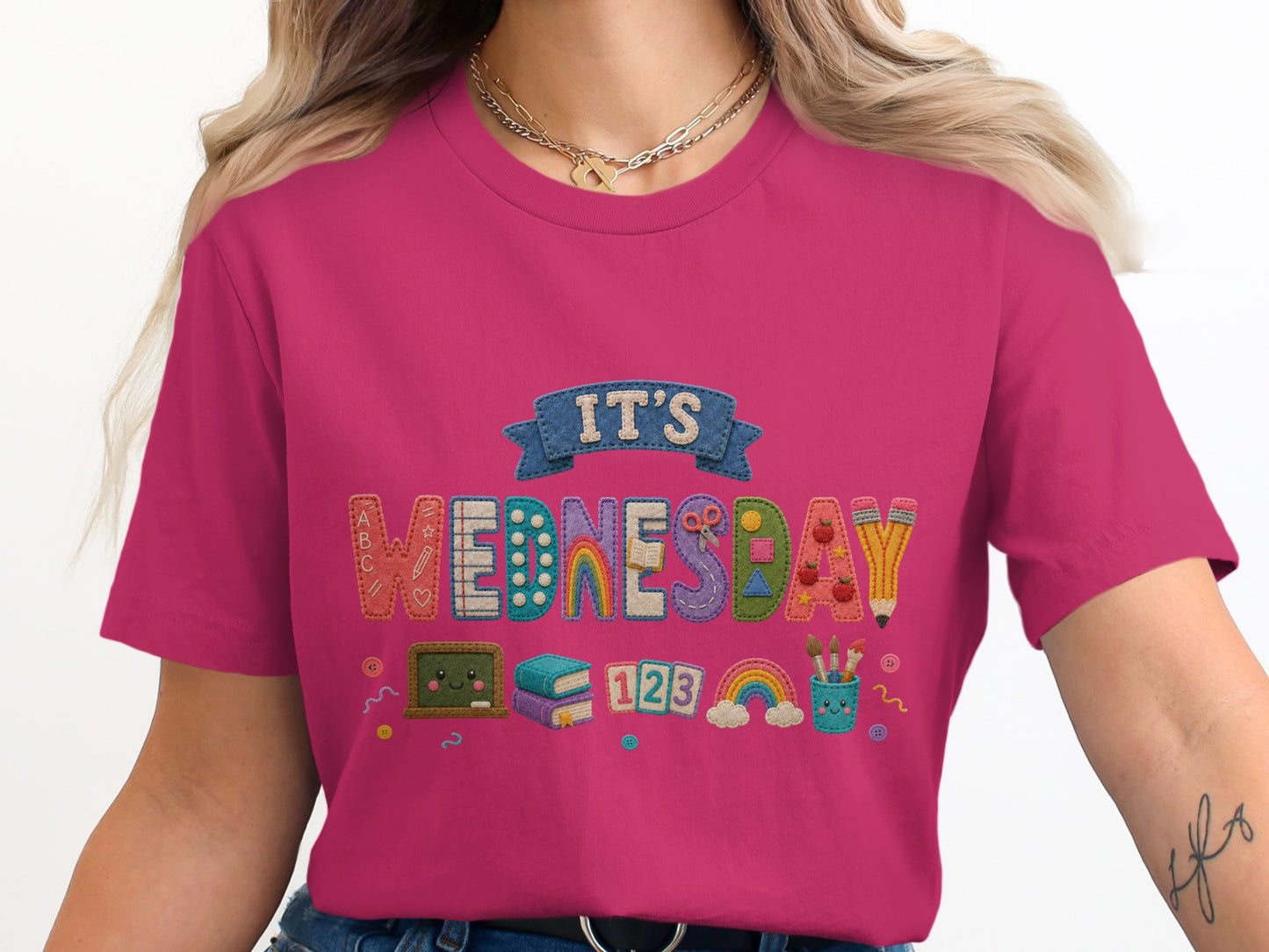 Pink shirt with "It's Wednesday" text and classroom graphics.