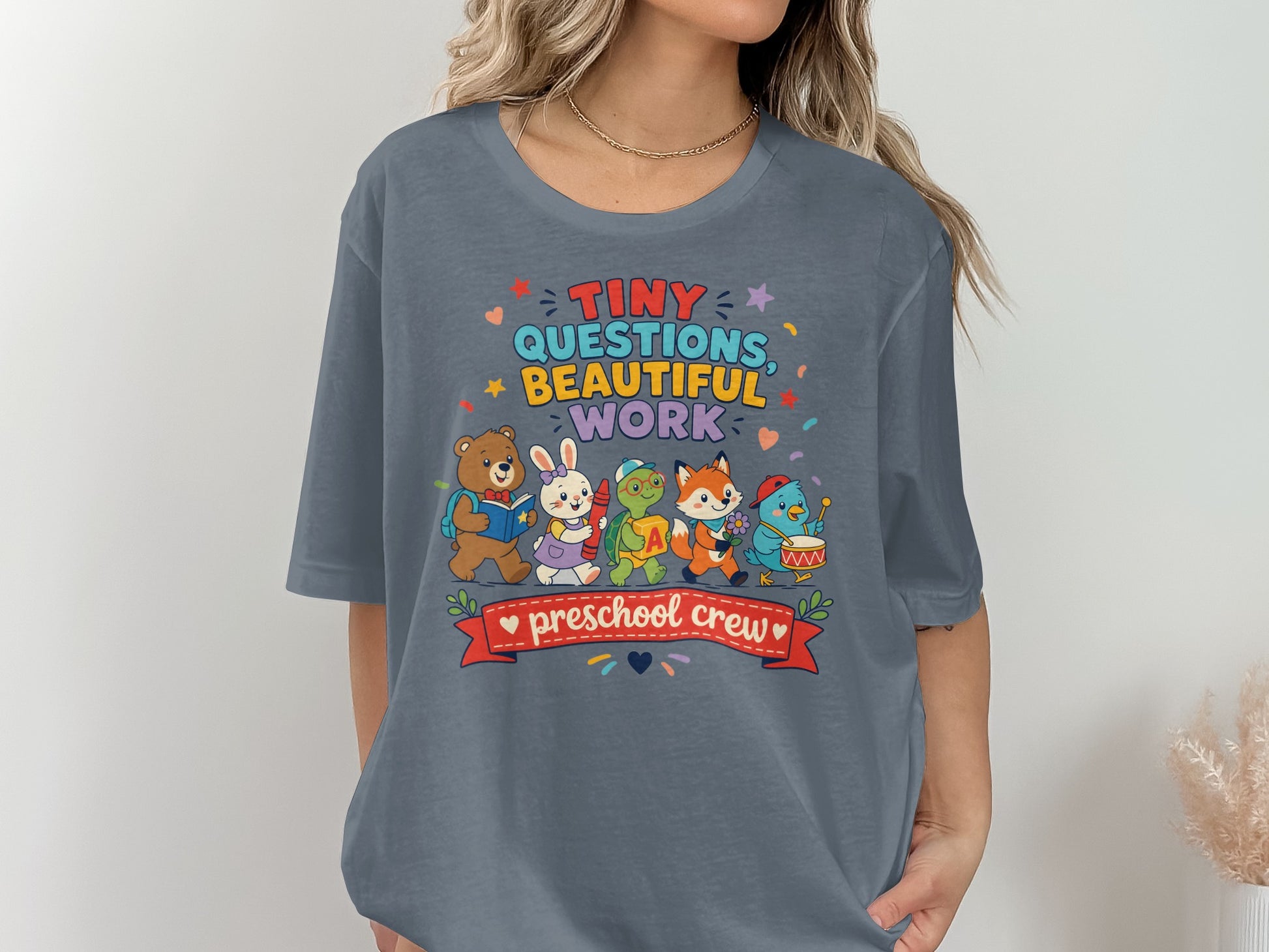 T-shirt with "Tiny Questions, Beautiful Work, Preschool Crew" and cartoon animals