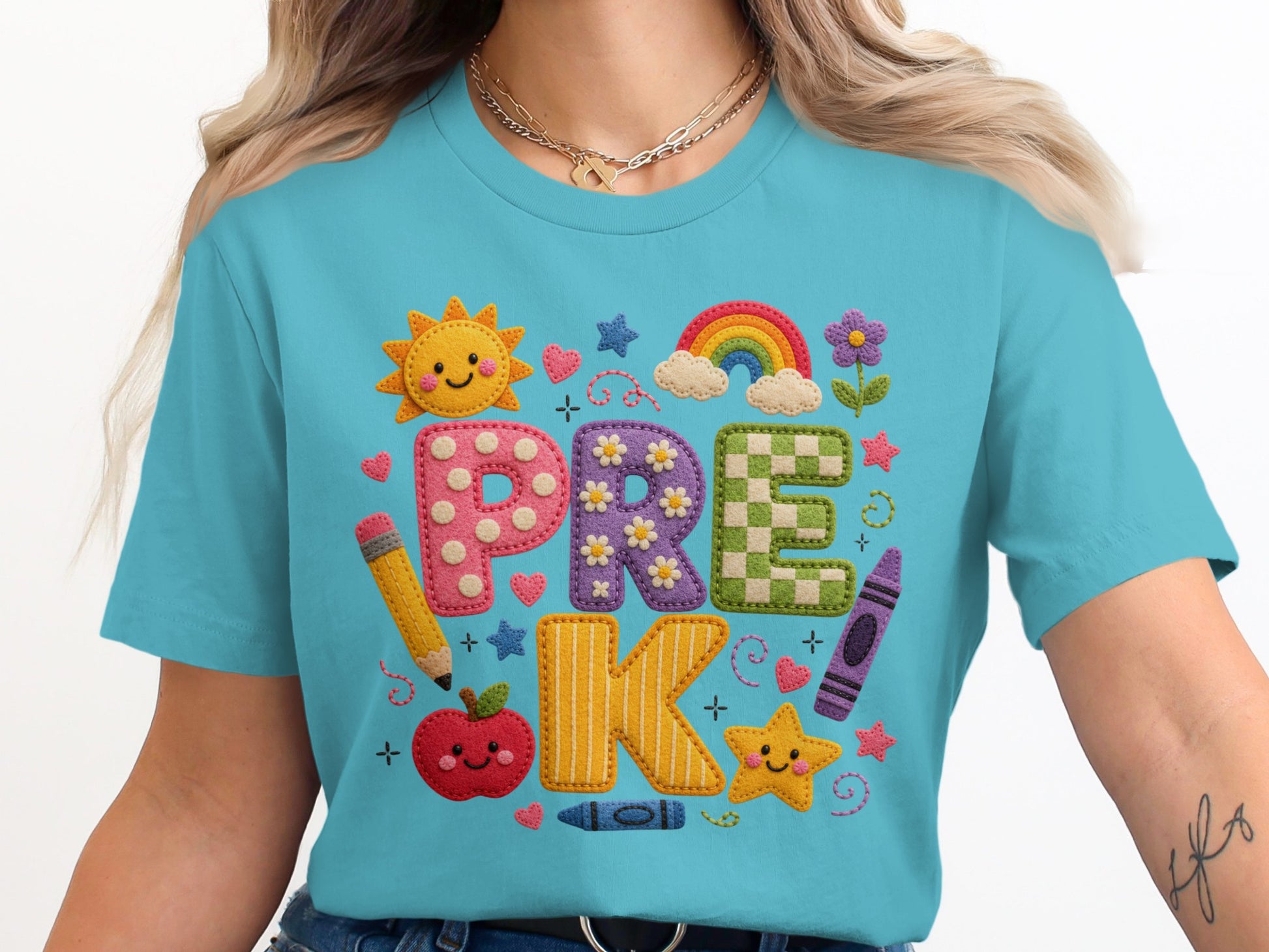 "PRE K" text with school-themed icons on a blue t-shirt.