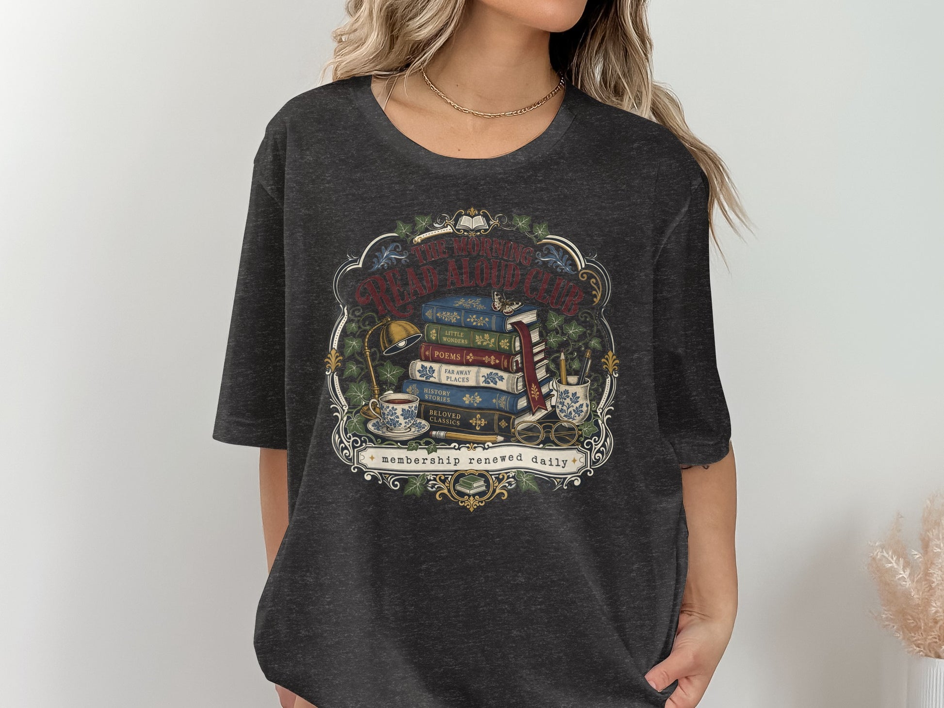 Graphic tee with vintage illustration of books, tea, and reading accessories.