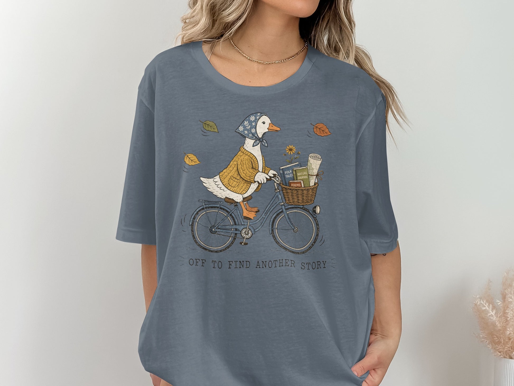 Illustration of a duck on a bicycle with a basket of books, surrounded by fall leaves.