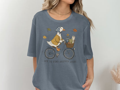 Illustration of a duck on a bicycle with a basket of books, surrounded by fall leaves.