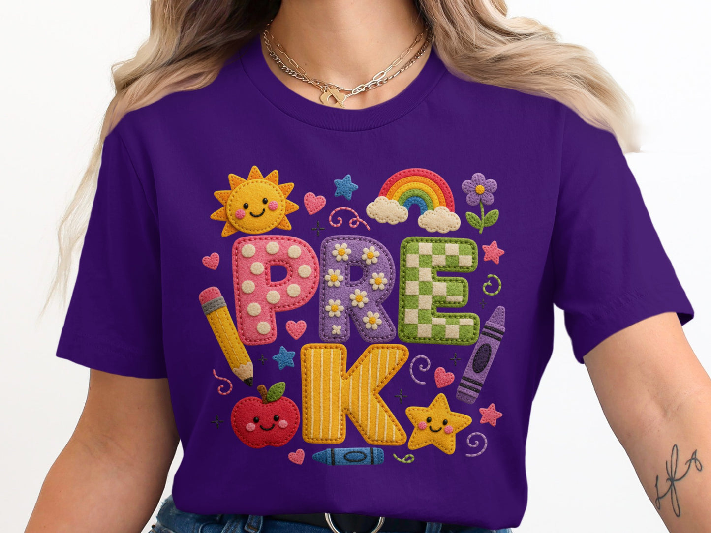 Purple t-shirt with "PRE-K" graphic featuring school supplies and cute characters.