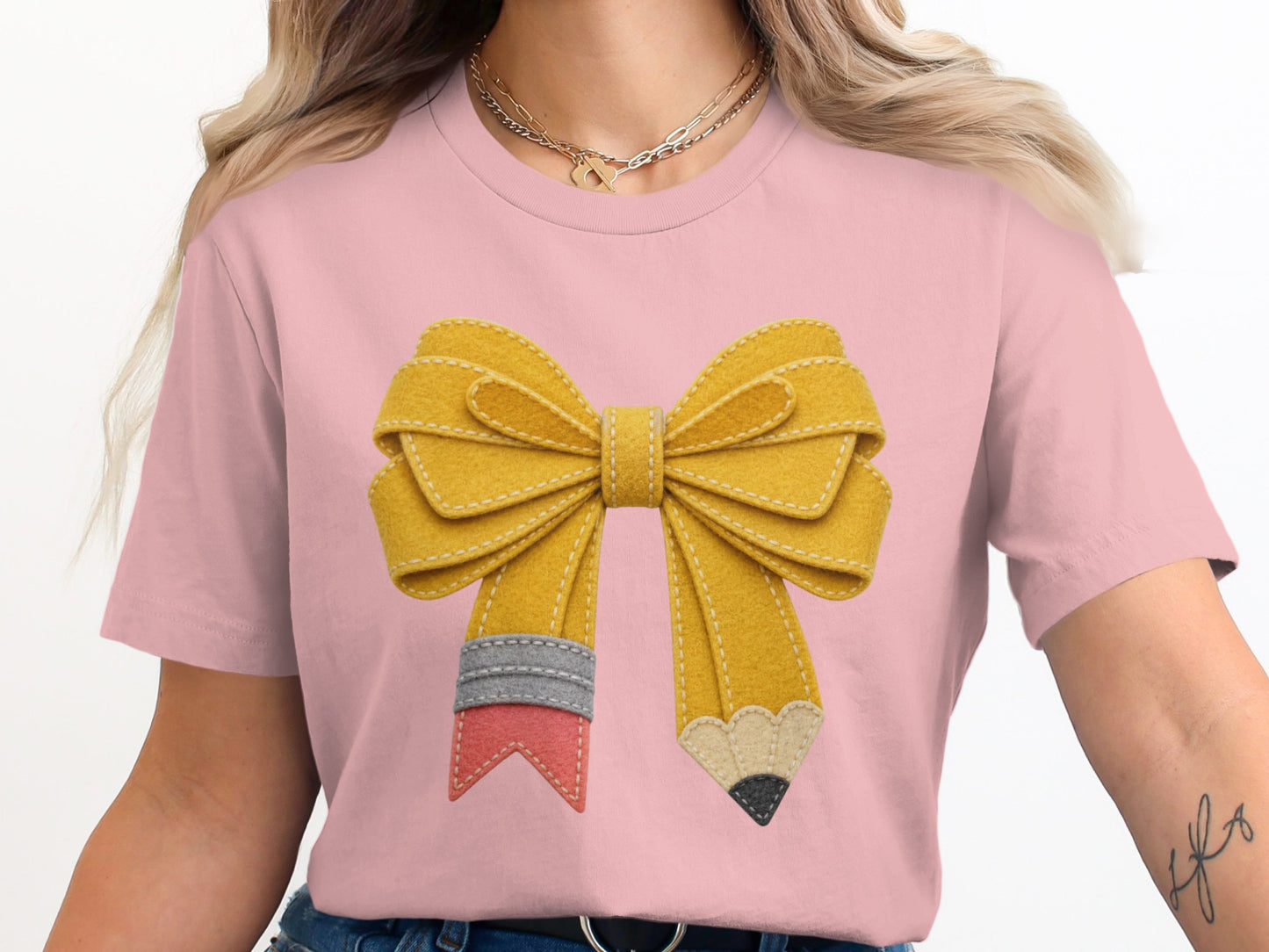 Pink t-shirt with felt yellow pencil bow graphic on chest.