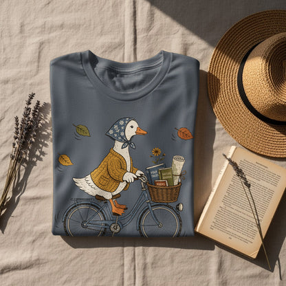 Duck wearing a scarf and sweater riding a bicycle with books in basket.