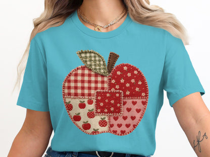 Patchwork apple graphic on a light blue t-shirt.