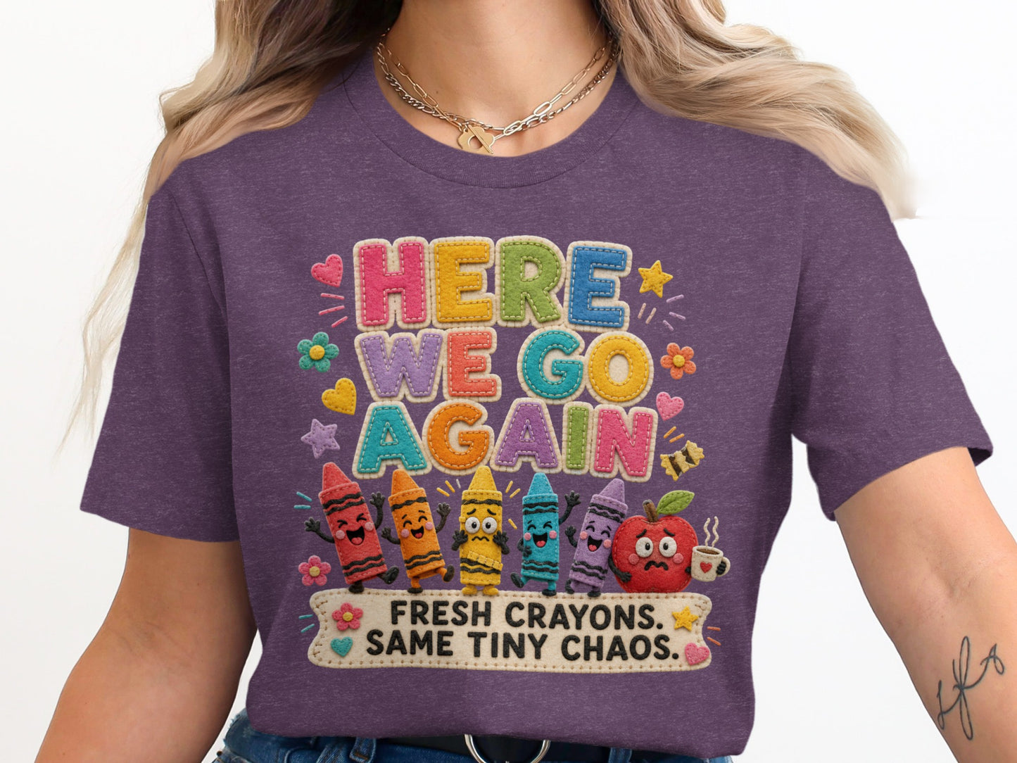 Purple t-shirt with "HERE WE GO AGAIN" and "FRESH CRAYONS. SAME TINY CHAOS." text.