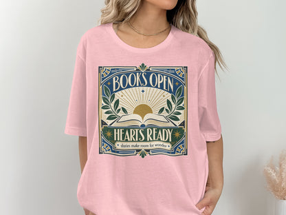 Pink t-shirt with "BOOKS OPEN HEARTS READY stories make room for wonder" graphic.