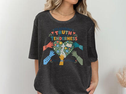 T-shirt graphic "Teaching Truth With Tenderness" with colorful hands reaching towards a heart-shaped garden.