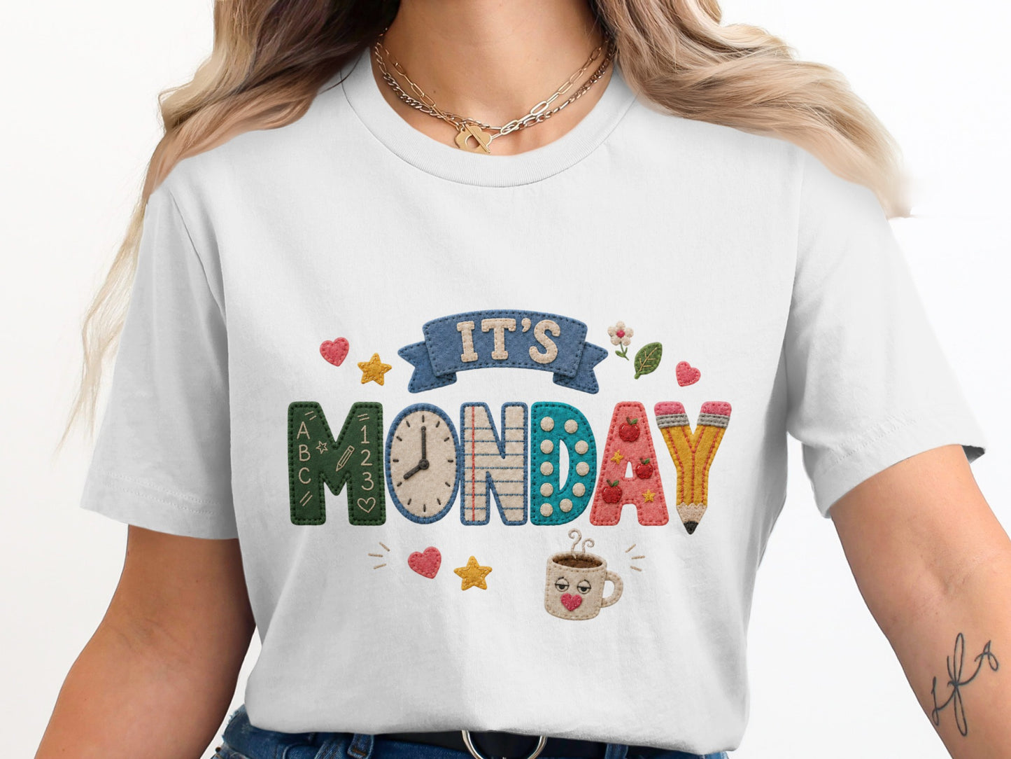 White t-shirt with "IT'S MONDAY" graphic featuring school-themed elements.
