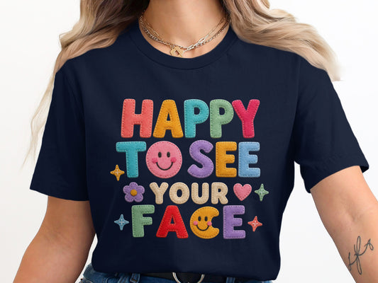 Navy t-shirt with colorful felt letters reading "HAPPY TO SEE YOUR FACE".