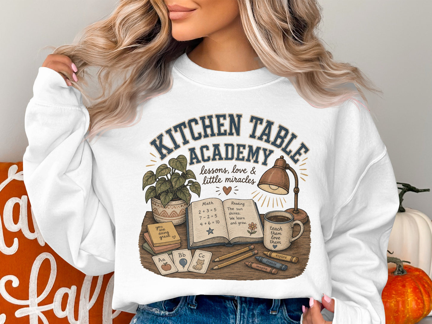 Sweatshirt with "Kitchen Table Academy" and school-themed illustration.