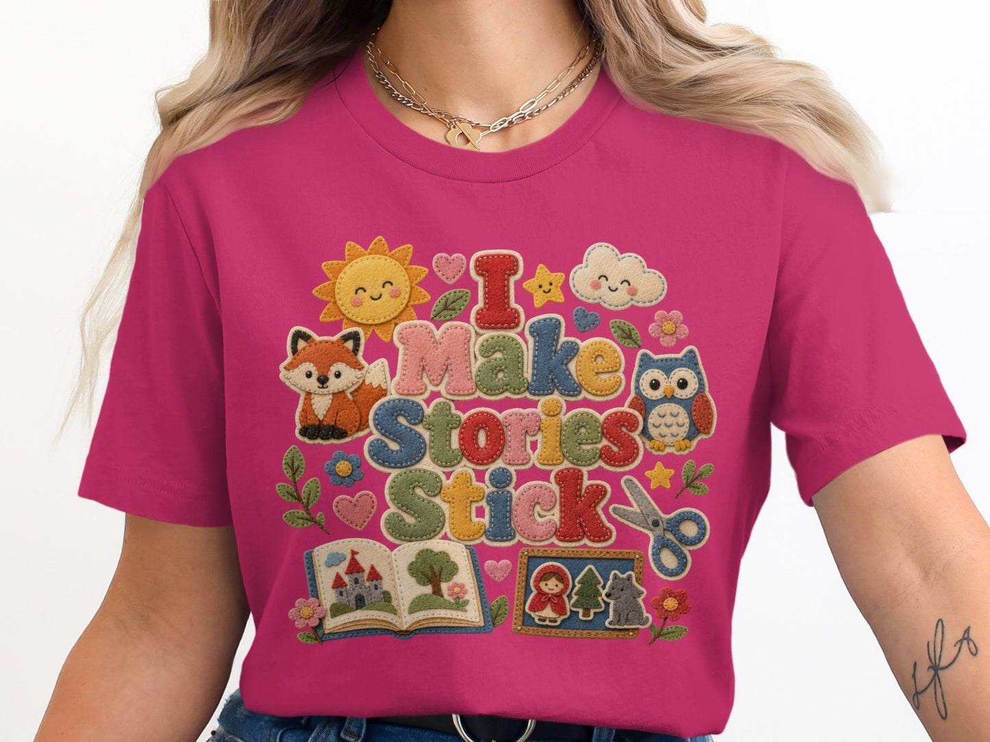 Bright pink t-shirt with "I Make Stories Stick" and assorted colorful storybook graphics.