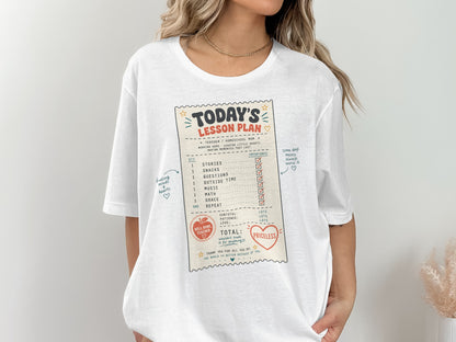 White shirt with "Today's Lesson Plan" design listing teacher tasks and a priceless total.