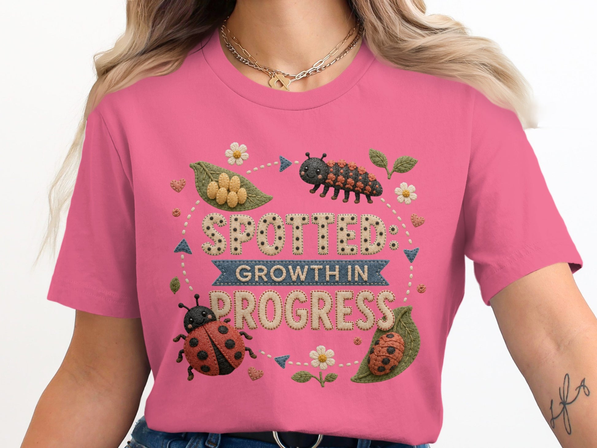 T-shirt with a "Spotted: Growth in Progress" graphic featuring ladybugs and a caterpillar.