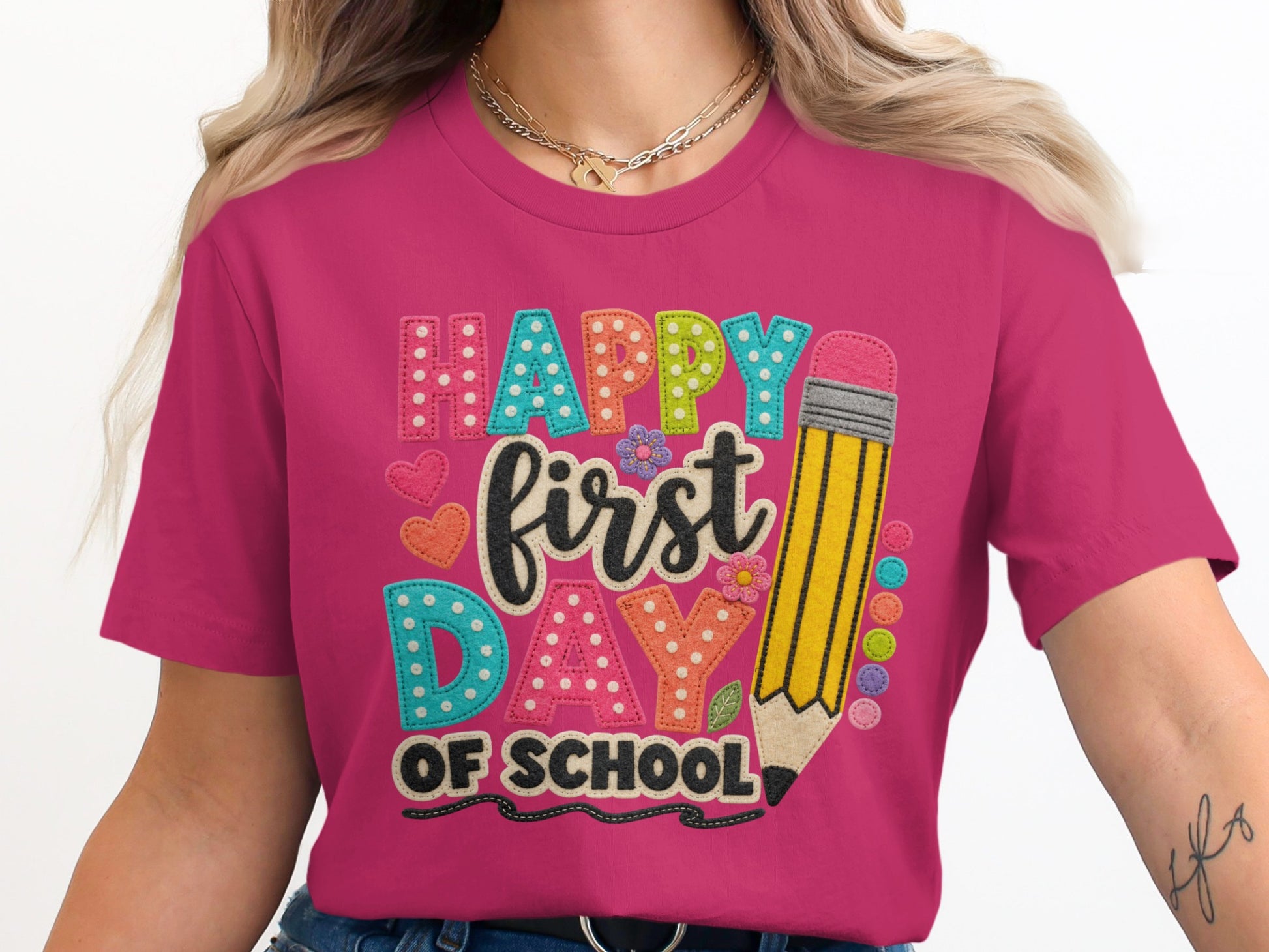 Pink t-shirt with "Happy First Day Of School" text and a large pencil graphic.